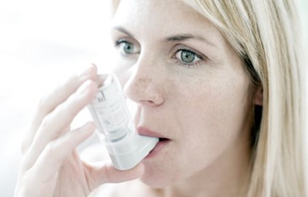 Mujer que utiliza un inhalador.